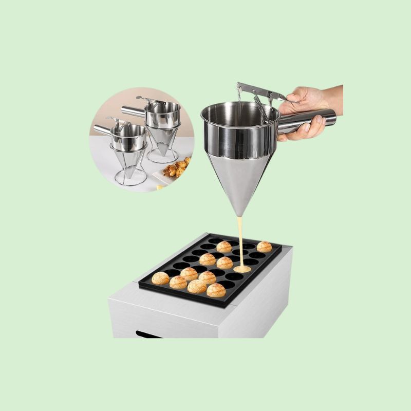 Distributeur de pâte en inox en train de remplir des moules à cupcakes
