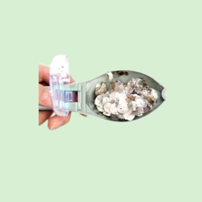 Écailleur de poisson en plastique contenant des écailles.