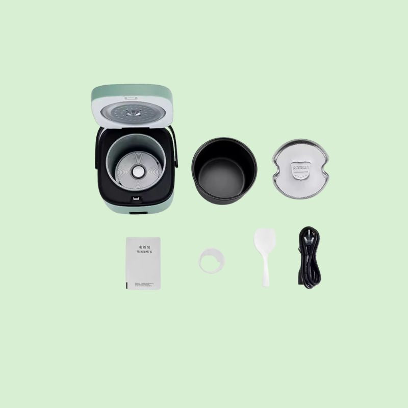Mini cuiseur à riz électrique avec ses pièces détachables visibles : couvercle, bol intérieur et cuve, montrant la facilité de nettoyage.