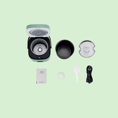 Mini cuiseur à riz électrique avec ses pièces détachables visibles : couvercle, bol intérieur et cuve, montrant la facilité de nettoyage.