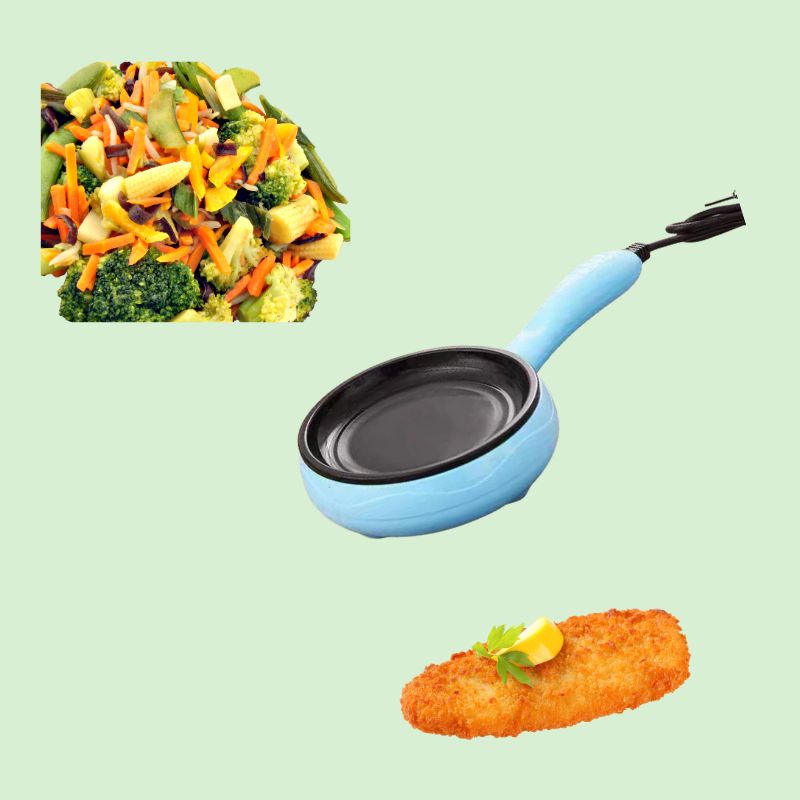 Mini poêle électrique entourée de légumes sautes et de poisson